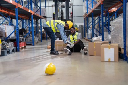 Photo for African americans working in warehouse got accident from carry box, forklift truck working near by - Royalty Free Image