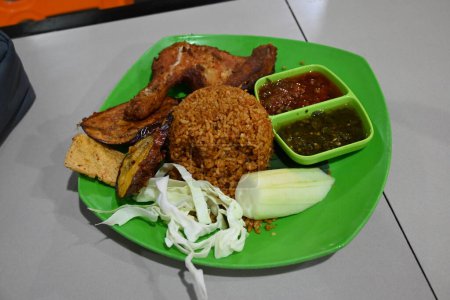 Photo for Nasi Goreng Ayam Penyet sambal ijo or chicken fried rice with Green Sambal. - Royalty Free Image