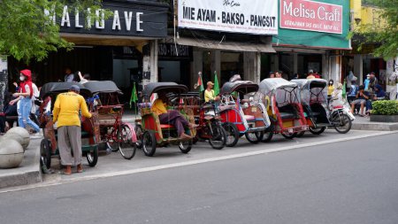 Photo for Bicycle rickshaws on Jalan Malioboro are a mode of transportation in Yogyakarta Indonesia: Yogyakarta-Indonesia, December 27, 2022. - Royalty Free Image