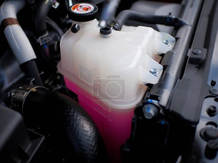 Photo for Radiator reservoir tank car engine coolant anti-coolant and anti-freeze, pink coolant - Royalty Free Image
