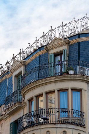 Foto de Street view of the facade of the old building, paris style open balcony under the roof. - Imagen libre de derechos