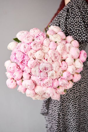 Cute and lovely peony. many layered petals. Bunch pale pink peonies flowers light gray background. Wallpaper,