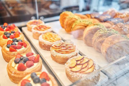 Photo for A variety of fresh pastries in the bakery window. almond croissant is fresh and hot in a cafe next to other types of pastries. The interior of an Italian restaurant. High quality photo - Royalty Free Image