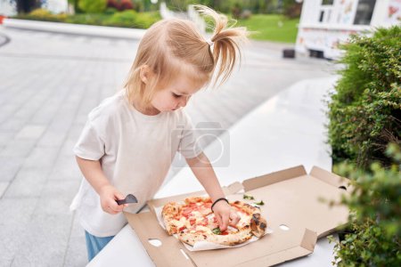 Photo for Pizza delivery concept. Baking in a cardboard box on a wooden background. Baked a delicious pizza Margarita in a traditional wood-burning oven in a Neapolitan restaurant, Italy. High quality photo - Royalty Free Image