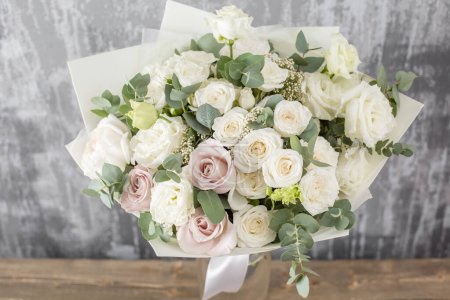 Photo for White Beautiful bouquet of mixed flowers in woman hand. Floral shop concept . Beautiful fresh cut bouquet. Flowers delivery. High quality photo - Royalty Free Image
