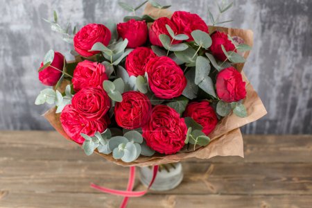Photo for Red Beautiful bouquet of mixed flowers in woman hand. Floral shop concept . Beautiful fresh cut bouquet. Flowers delivery. High quality photo - Royalty Free Image