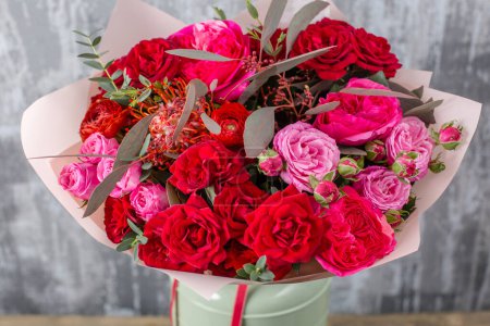 Photo for Red Beautiful bouquet of mixed flowers in woman hand. Floral shop concept . Beautiful fresh cut bouquet. Flowers delivery. High quality photo - Royalty Free Image
