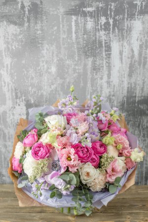 Photo for Small Beautiful bouquet of mixed flowers in woman hand. Floral shop concept . Beautiful fresh cut bouquet. Flowers delivery. High quality photo - Royalty Free Image