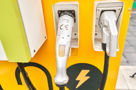 Photo for Power supply for electric car charging. Electric car charging station. Close up of the power supply plugged into an electric car being charged. High quality photo. - Royalty Free Image
