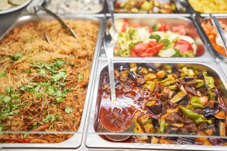 Photo for Various hot dishes. Glass Showcase in a buffet or self-service restaurant. High quality photo - Royalty Free Image