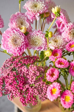 Photo for A beautiful bouquet of pink and white flowers fills a vase on a table, creating a lovely centerpiece - Royalty Free Image