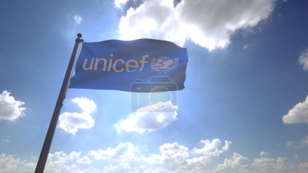 Téléchargez les photos : UNICEF Flag waving on a Flagpole in front of a blue sky with clouds - en image libre de droit