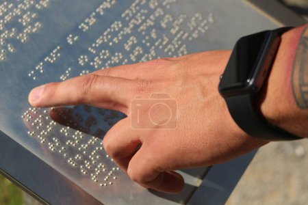 Explore the world of tactile communication as hands delicately navigate the raised dots of braille language