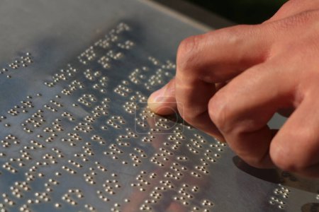 Explore the world of tactile communication as hands delicately navigate the raised dots of braille language