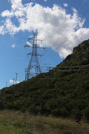 Towering electric structures dot the landscape, their imposing presence symbolizing the intricate network that powers modern civilization, evoking a sense of awe and wonder