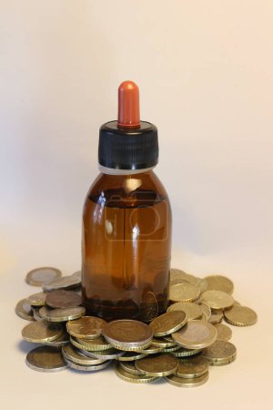 Beauty oil delicately balances atop a mound of coins, symbolizing the cost of luxury in beauty products