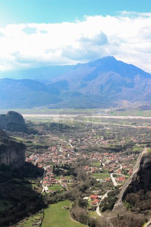 Immerse yourself in the panoramic beauty of Kalambaka, Greece, as seen from the timeless vantage point of the monasteries perched atop the towering cliffs of Meteora