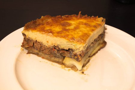 Indulge in the rich culinary tradition of the Mediterranean with this enticing plate of moussaka. Layers of tender eggplant, savory minced meat, and creamy bechamel sauce come together in a symphony