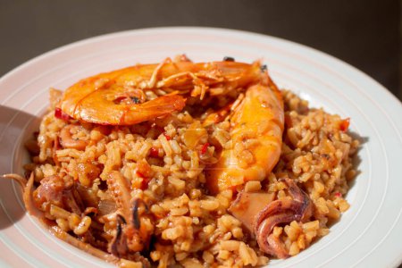 Indulge in the iconic flavors of Spain with a tantalizing plate of paella, showcasing a vibrant medley of seafood, rice, and aromatic spices.