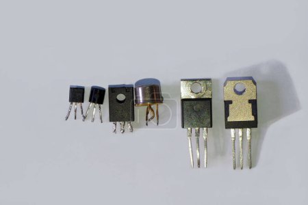 Photo for Transistor package types. Semiconductor components isolated on grey. - Royalty Free Image