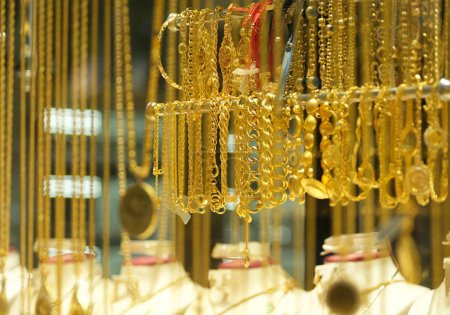 Shiny jewelery showcase. Gold jewelry. Precious metals and gold marketing background. Selected focus.