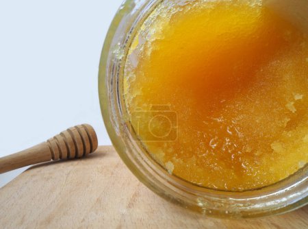 Photo for Isolated crystallized honey in a glass jar. Selected focus. - Royalty Free Image