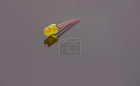 Isolated single yellow Light Emitting Diode (led) on the gray.