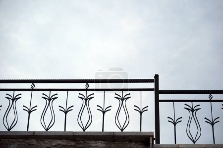 Wrought iron on the metal stair railing.