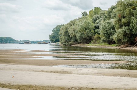 The sandy bank of the Danube River near the city of Novi Sad. Panorama banks of the river Danube near the Petrovaradin. One of the city's beaches - Oficirac in Novi Sad.