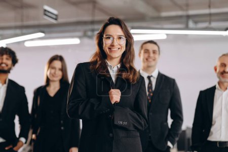 Téléchargez les photos : Female leadership in business. Confident businesswoman leading her team. Front view of diverse coworkers on blurred background. High quality photo - en image libre de droit
