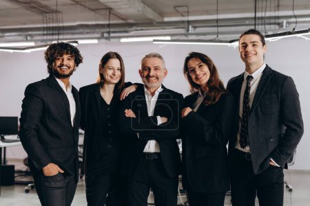 Photo for Diverse business team in black costumes. Indoor shot of business partners looking at camera with smile. Business opportunities, career growth. High quality photo - Royalty Free Image