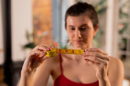 Photo for Woman checking results after waistline measuring. Dieting concept, losing weight, calorie control. High quality photo - Royalty Free Image