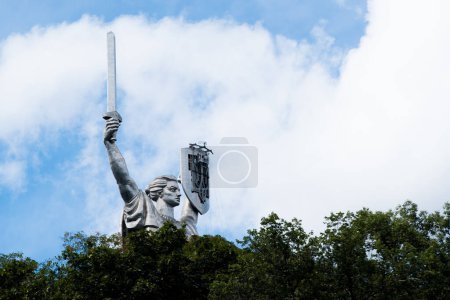 Photo for Kyiv, Ukraine - August 11, 2023: Motherland or Mother Ukraine monument. new replaced trident, Ukrainian national symbol, coat of arms, which was installed instead of the Soviet Union coat of arms - Royalty Free Image