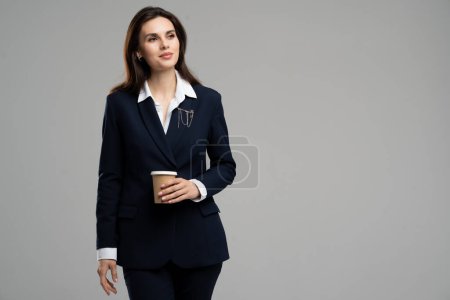 Photo for Photo of confident business lady young age wear suit drink milk chocolate bring coffee to go look copyspace. Pretty woman relax workplace hold cup. High quality photo - Royalty Free Image