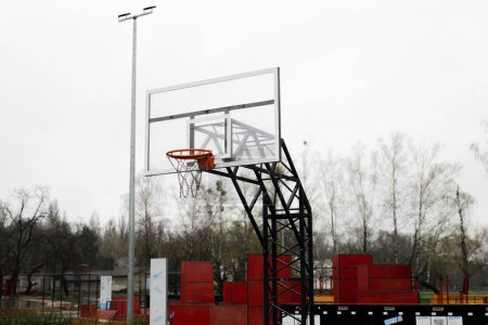 Photo for Basket hoop on sports playground. Concept of streetball game in park. Free space for healthy leisure. Location using amateur basketball players outdoors. High quality photo - Royalty Free Image