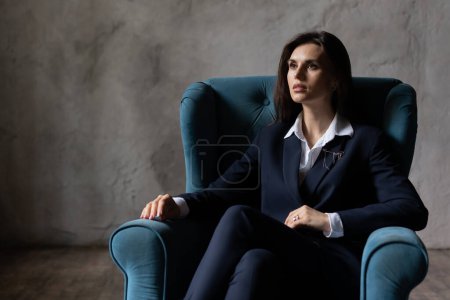 Photo for Thoughtful businesswoman sitting in her comfortable armchair. Confident woman dreaming and looking copy space. Business lady relaxed ceo big company isolated on gray background. High quality photo - Royalty Free Image