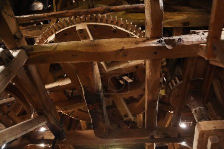 Photo for A huge wooden gear, the mechanism of the old mill made entirely of wood. The inner mechanism of an old mill. Interesting and informative historical facts. Ancient mechanism - Royalty Free Image