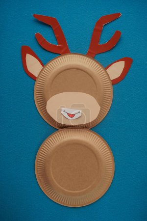 Foto de Christmas New Year Santa's deer handmade. Step by step photo instruction. DIY concept. Step 7-13. Cut out a white oval, draw a funny mouth on it and glue it to the face of a deer. Top view, Flat lay - Imagen libre de derechos