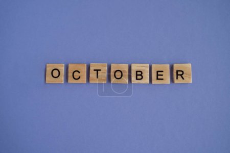 Photo for Tenth month of the year October - from isolated letters on wooden blocks in natural color, in high resolution. Very Peri Color of the Year background, copy space. Flat lay, step by step, step 10. - Royalty Free Image