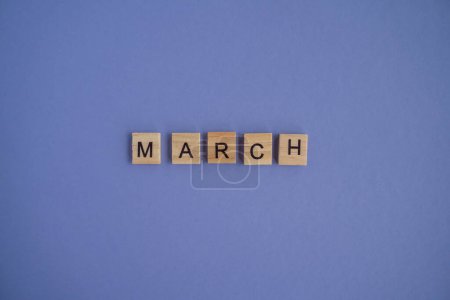 Photo for The third month of the year MARCH - from isolated letters on wooden blocks in natural color, in high resolution. Very Peri Color of the Year background, copy space. Flat lay, step by step, step 3. - Royalty Free Image