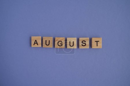 Photo for Eighth month of the year August - from isolated letters on wooden blocks in natural color, in high resolution. Very Peri Color of the Year background, copy space. Flat lay, step by step, step 8. - Royalty Free Image