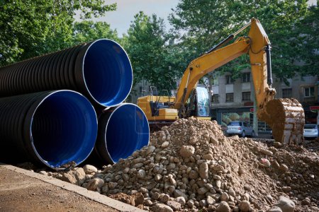 Photo for Large plastic corrugated pipes for water supply lie on the street in the city. The work of utilities to improve the infrastructure of the metropolis. - Royalty Free Image