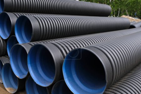 Photo for Close-up of large plastic corrugated pipes for water supply. Reconstruction of the pipeline and sewerage in the city. - Royalty Free Image