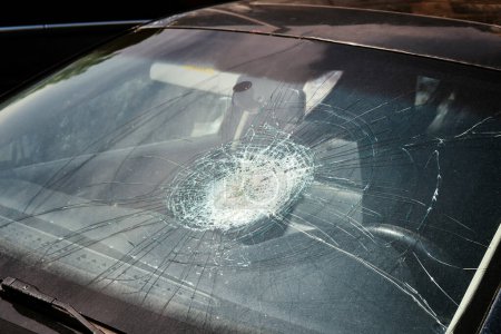 Broken windshield of a car after a collision with a pedestrian.