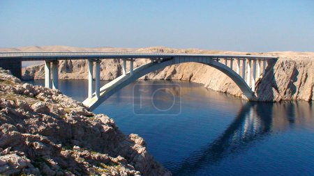 Photo for "Paski Most" is a road bridge, arch bridge with an upper deck and reinforced concrete bridge which was completed in 1968. It is located in Croatia near the city of Zadar. - Royalty Free Image
