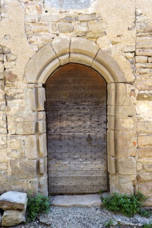 Photo for Old solid wood door of a house of Cordes sur Ciel, old medieval village elected favorite village of french, in the Tarn department in the Occitan region - Royalty Free Image