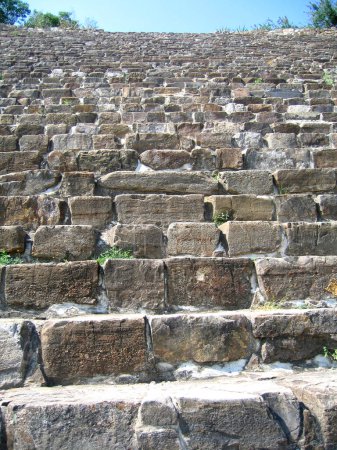 Foto de Antiguos asientos de teatro en Epidauro fueron construidos para los Juegos de Asclepio, en honor del dios médico Asclepio. Es famoso por su acústica excepcional y sirvió como modelo para muchos otros anfiteatros griegos. - Imagen libre de derechos