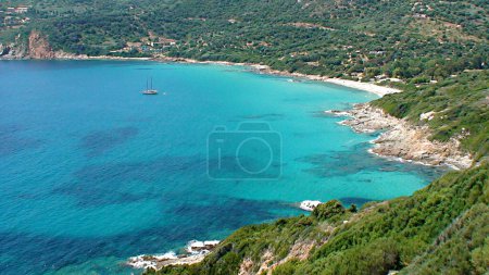 Photo for Chiuni beach is a pleasant little beach near Cargese, on the west coast of Corsica, nicknamed the island of beauty. It is a small corner of paradise made of fine golden sand, palm trees and above all a magnificent turquoise water. - Royalty Free Image