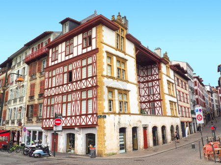 Photo for In Bayonne, in the Basque country, traditional white house with red and yellow half-timbering - Royalty Free Image