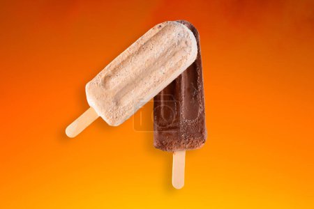 Photo for Peanut and chocolate popsicle with orange gradient background. - Royalty Free Image